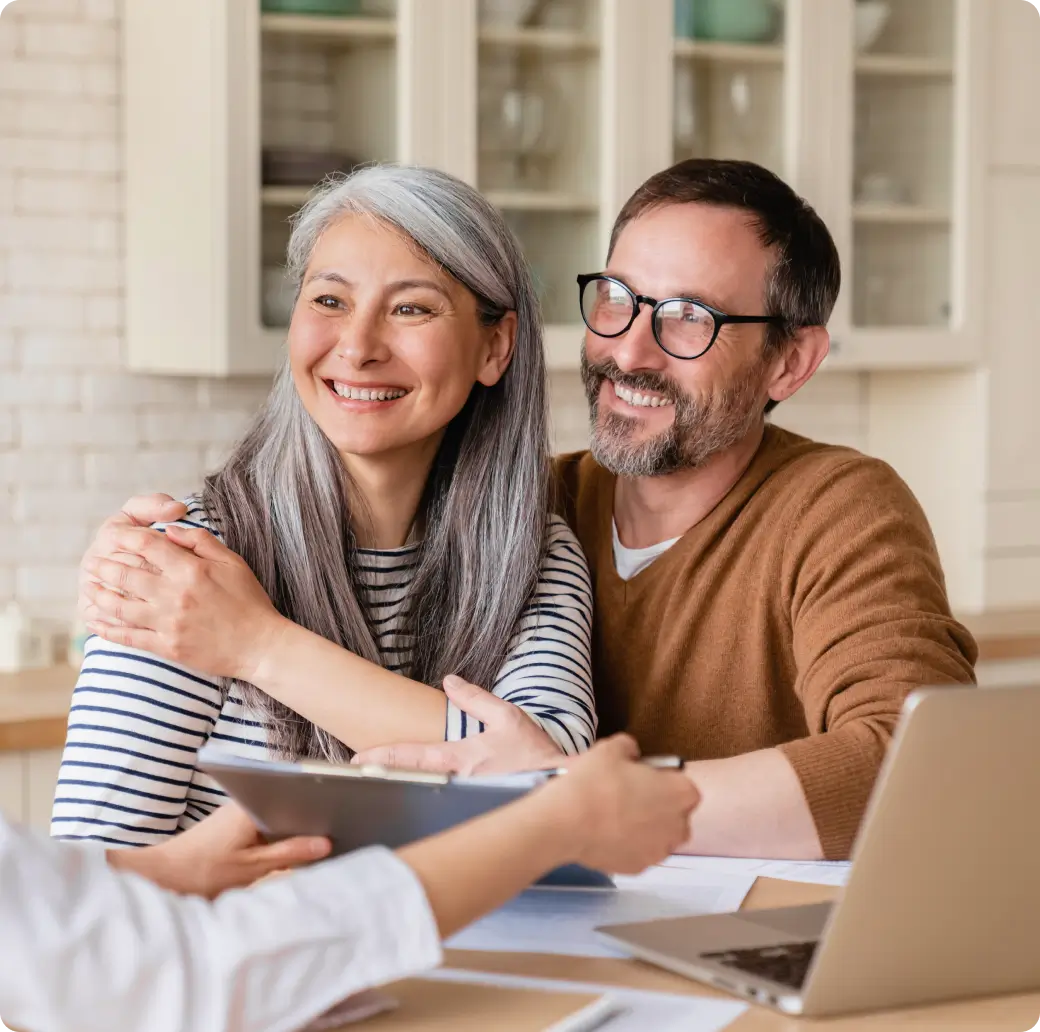 Happy senior couple discussing with a consultant